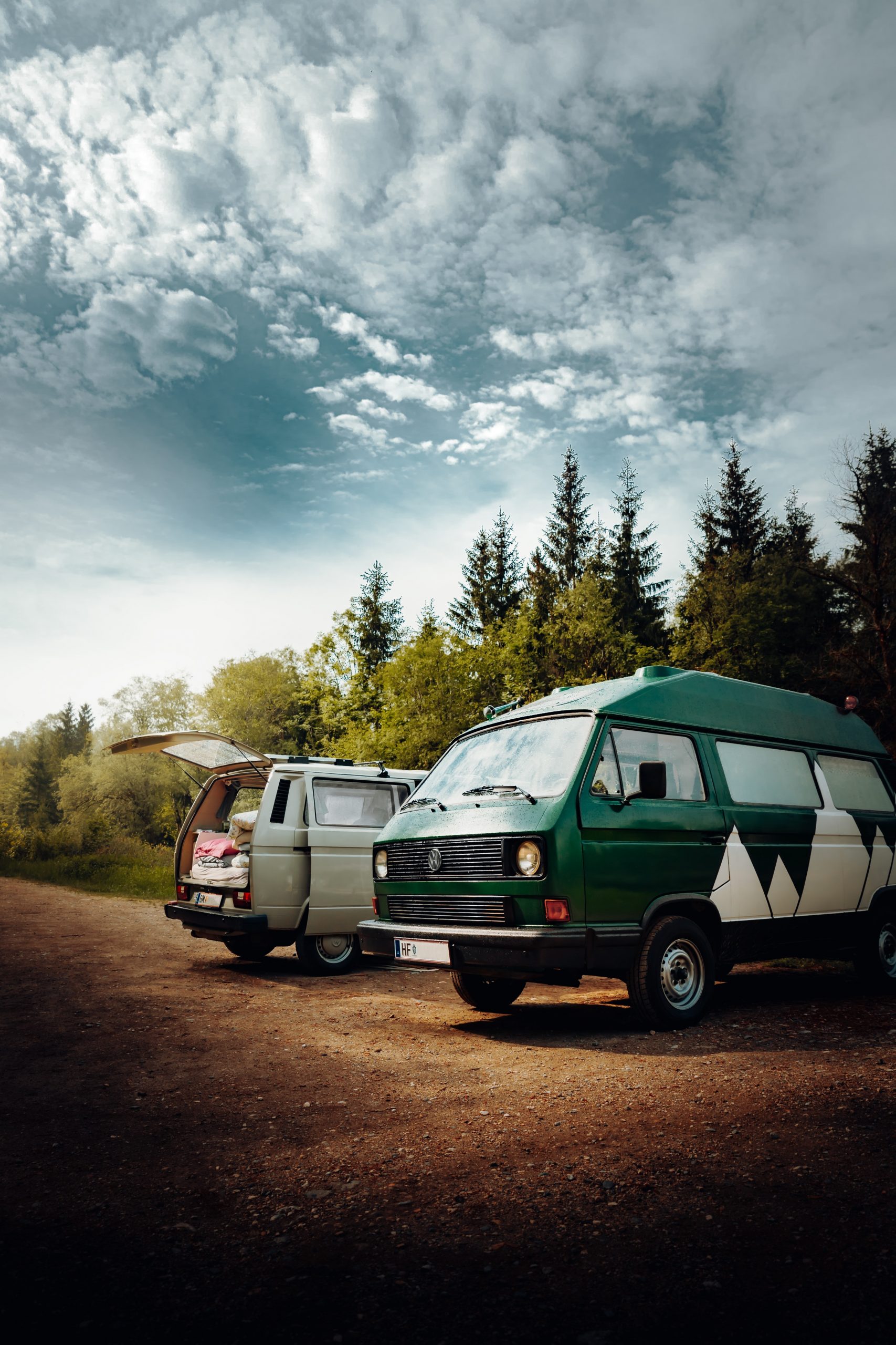 Two old vans on a roadtrip.